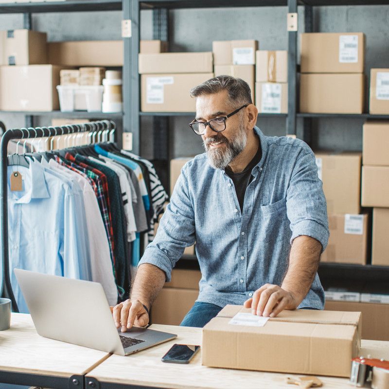 Business owner preparing a parcel for delivery in a stockroom