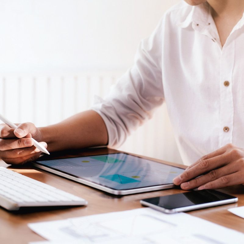 Person reviewing stock figures on a tablet at a desk